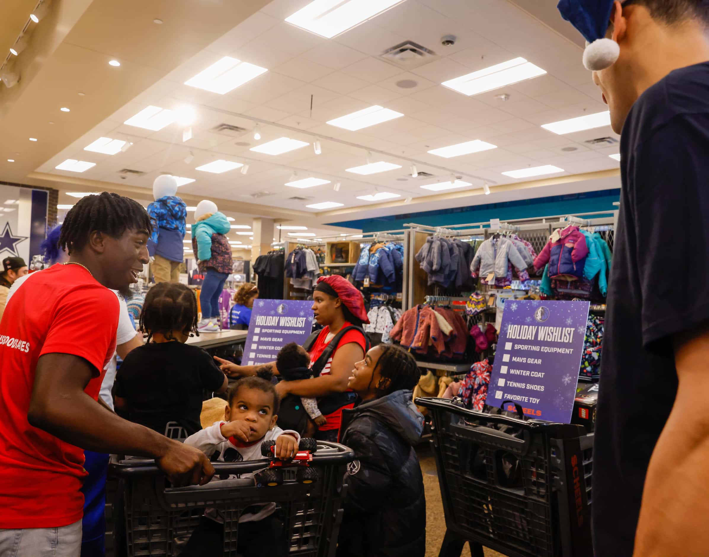 The Givens family looks for jackets for each of their four children while shopping with...