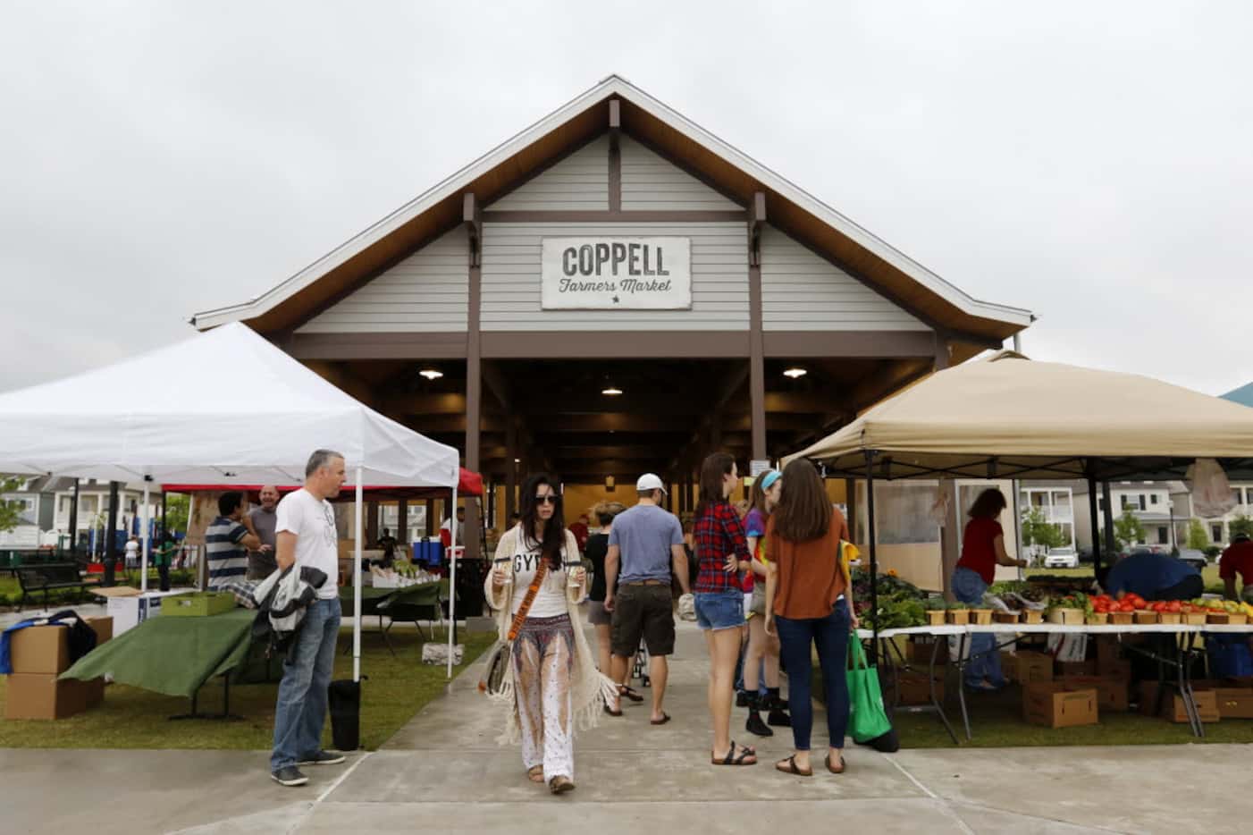 People browse the variety of goods available at the Coppell Farmers Market. (File Photo/Rose...