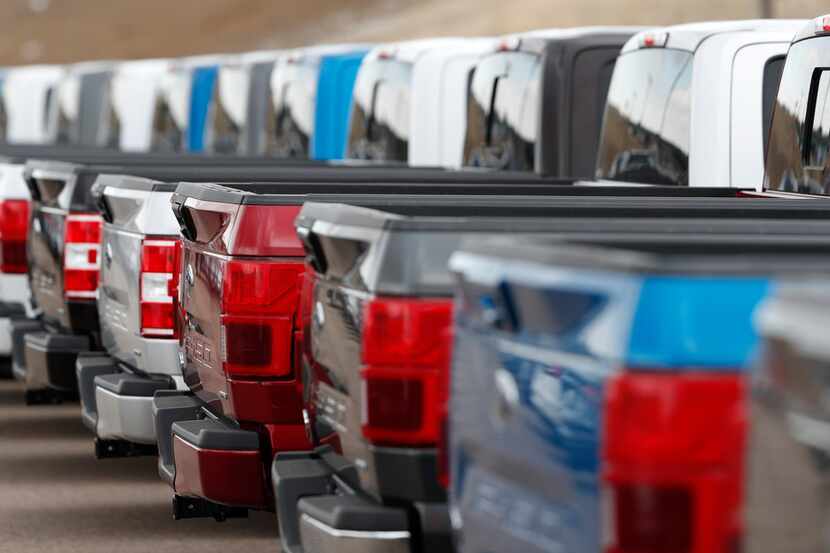 2019 F150 pickup trucks sit in a long row at a Ford dealership in Broomfield, Colo. 