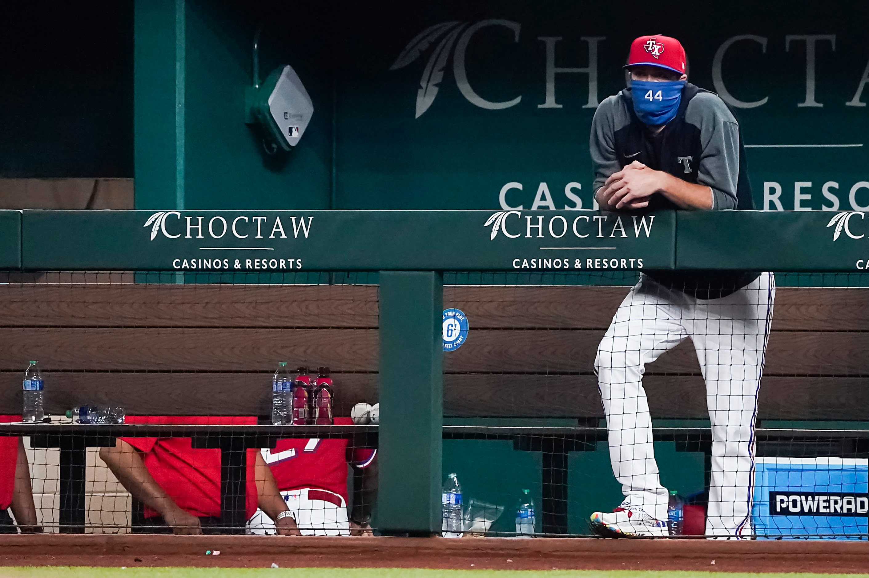 Texas Rangers pitcher Kyle Gibson watches from the dugout as San Diego Padres starting...