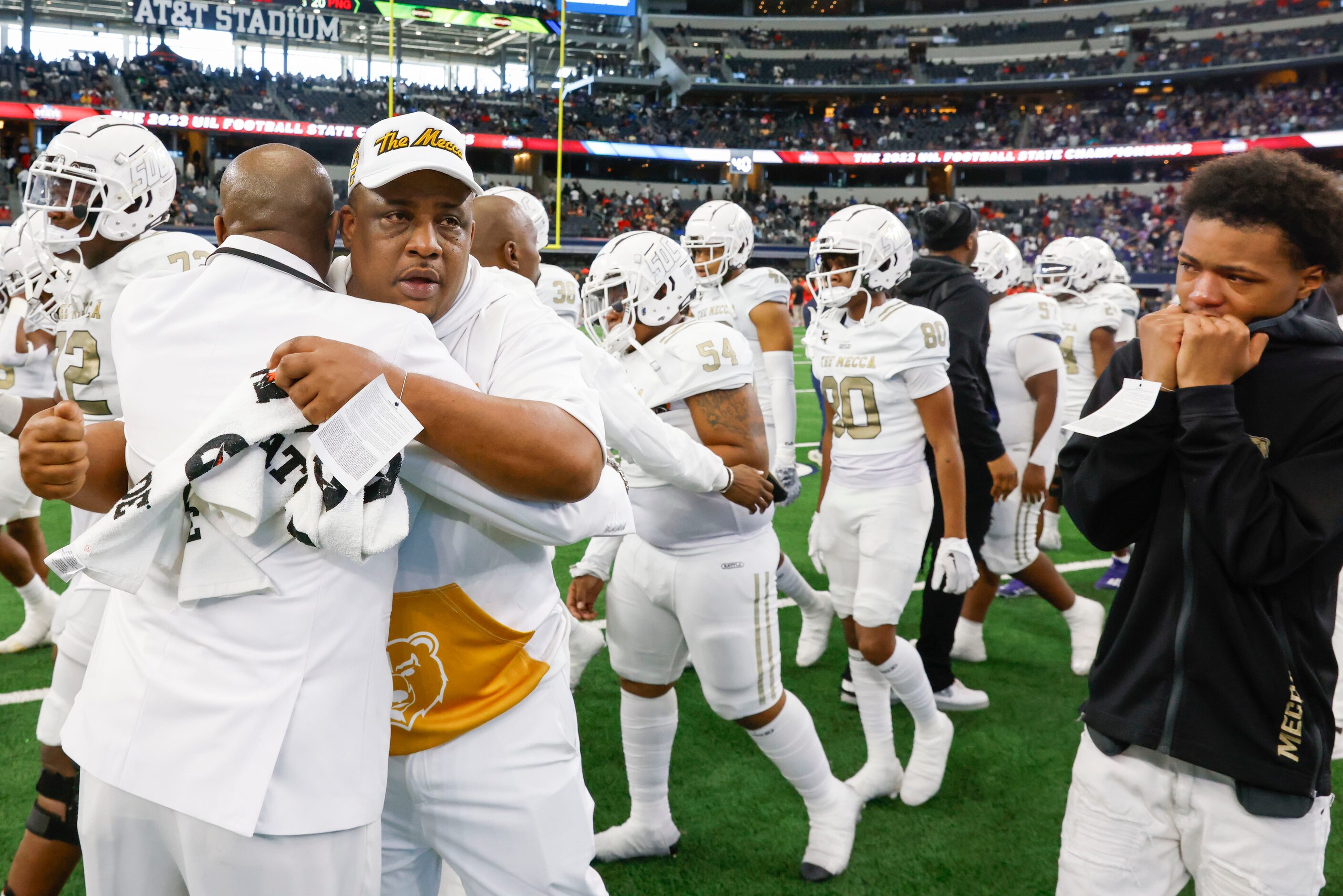 South Oak Cliff head coach Jason Todd (center right) gets comforted following his team’s...