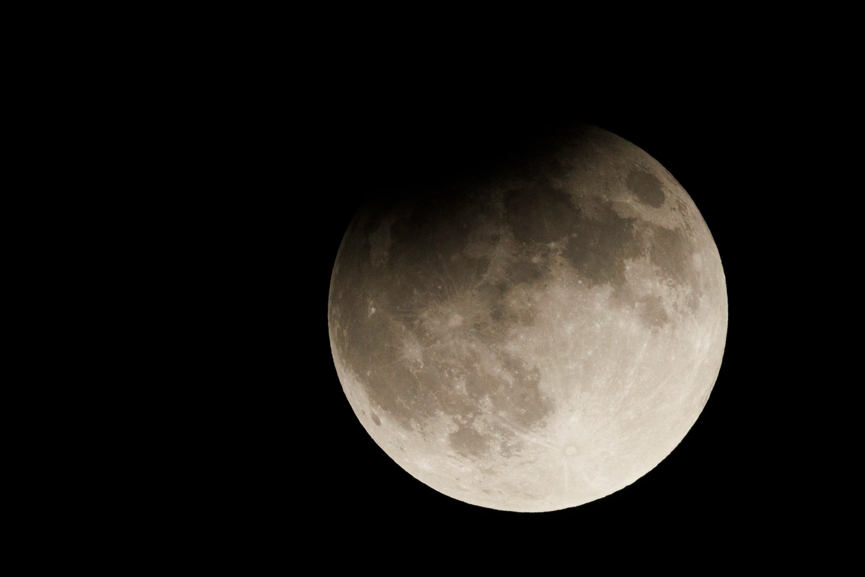 A partial lunar eclipse and supermoon is seen over Fort Worth, Tuesday, Sept. 17, 2024.