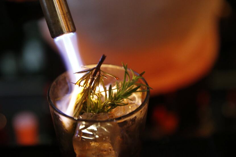 Co-founded Brian McCullough burns rosemary while preparing the cocktail called "Gringo in a...