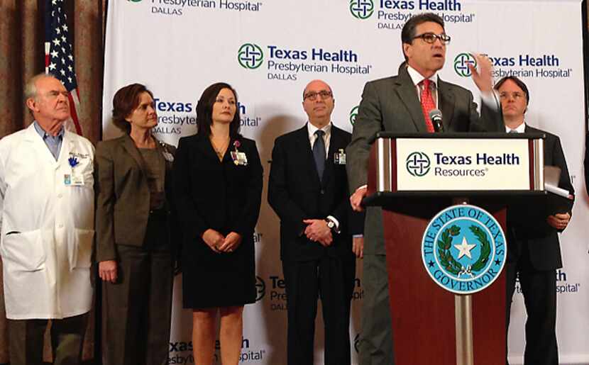 Texas Gov. Rick Perry speaks at the start of a news conference Wednesday at Texas Health...