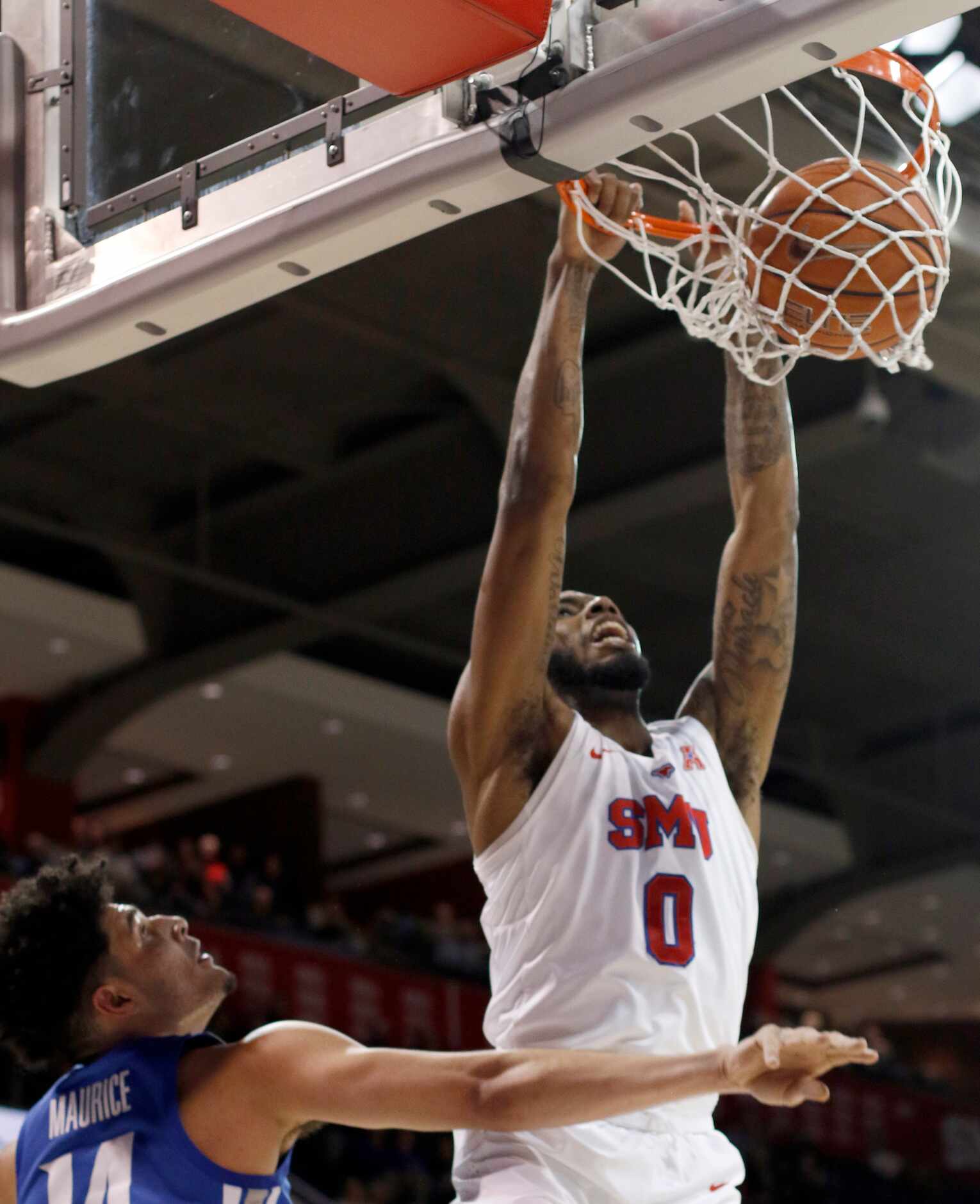 SMU guard Tyson Jolly (0) dunks over the defense of Memphis forward Isaiah Maurice (14)...