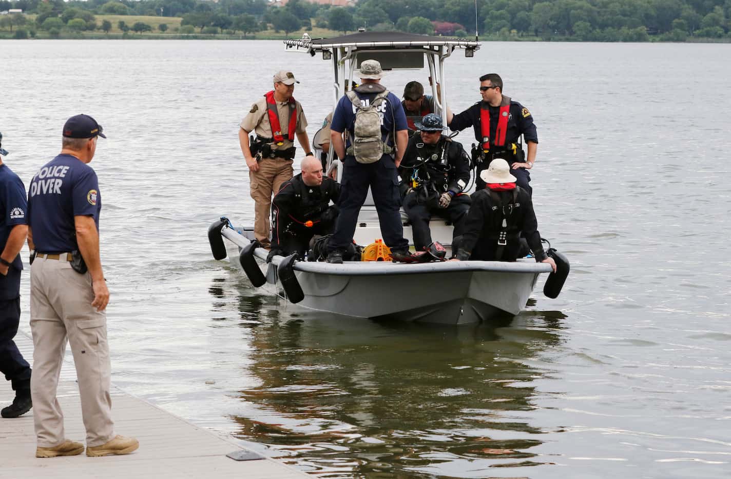 Sgt. Rod Dillon, dive team supervisor (left) watches as rescuers continue their search Monday.