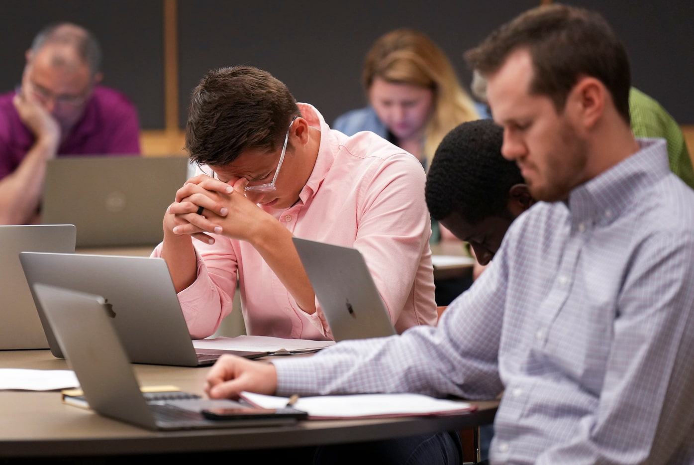 A staff meeting begins with a prayer at First Baptist Church of Dallas on Aug. 16.