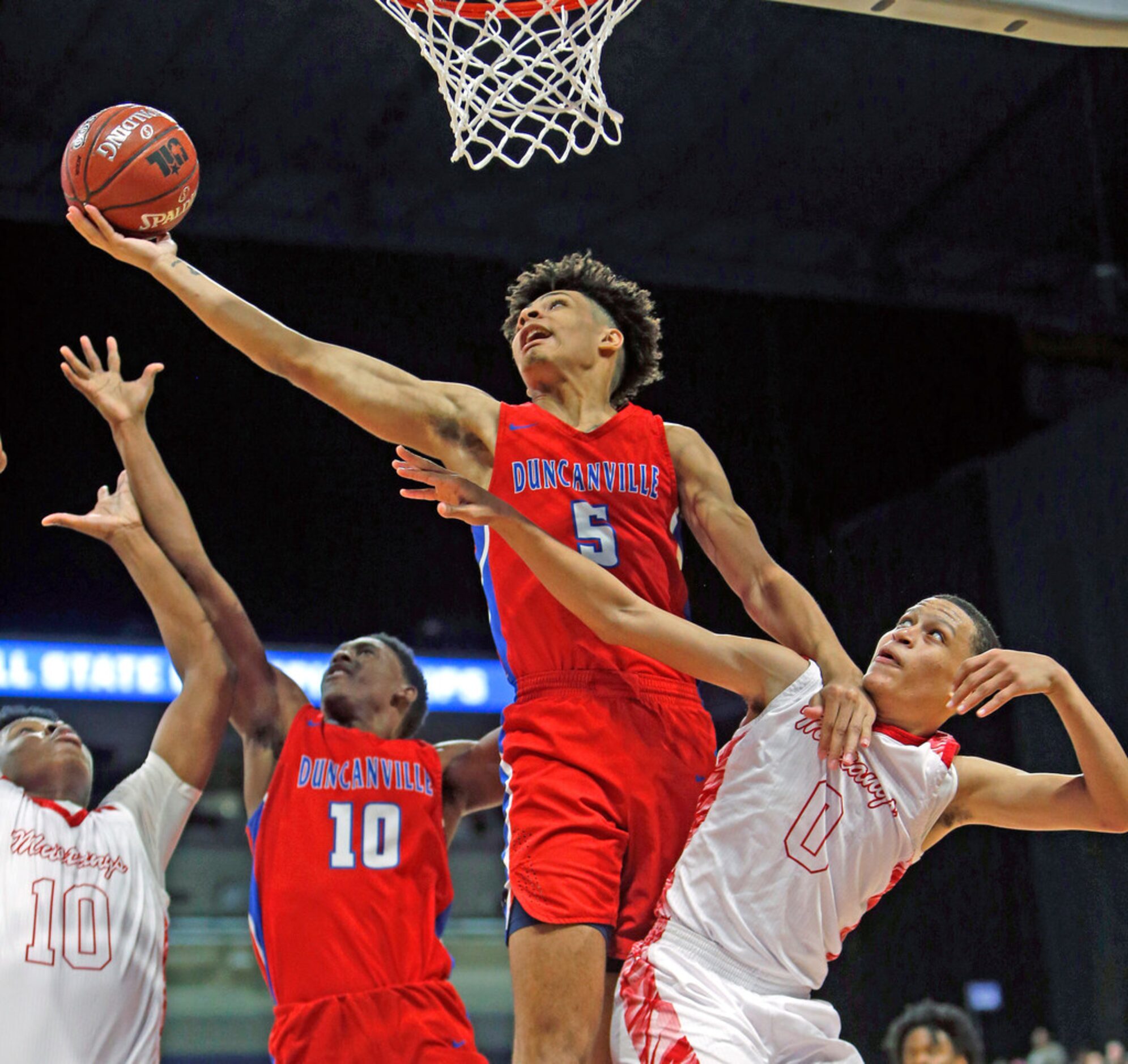 Duncanville's Micah Peavy #5 reaches for a rebound over Galena Park North's Joshua Cooper #0...