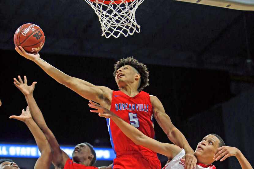 Duncanville's Micah Peavy #5 reaches for a rebound over Galena Park North's Joshua Cooper #0...