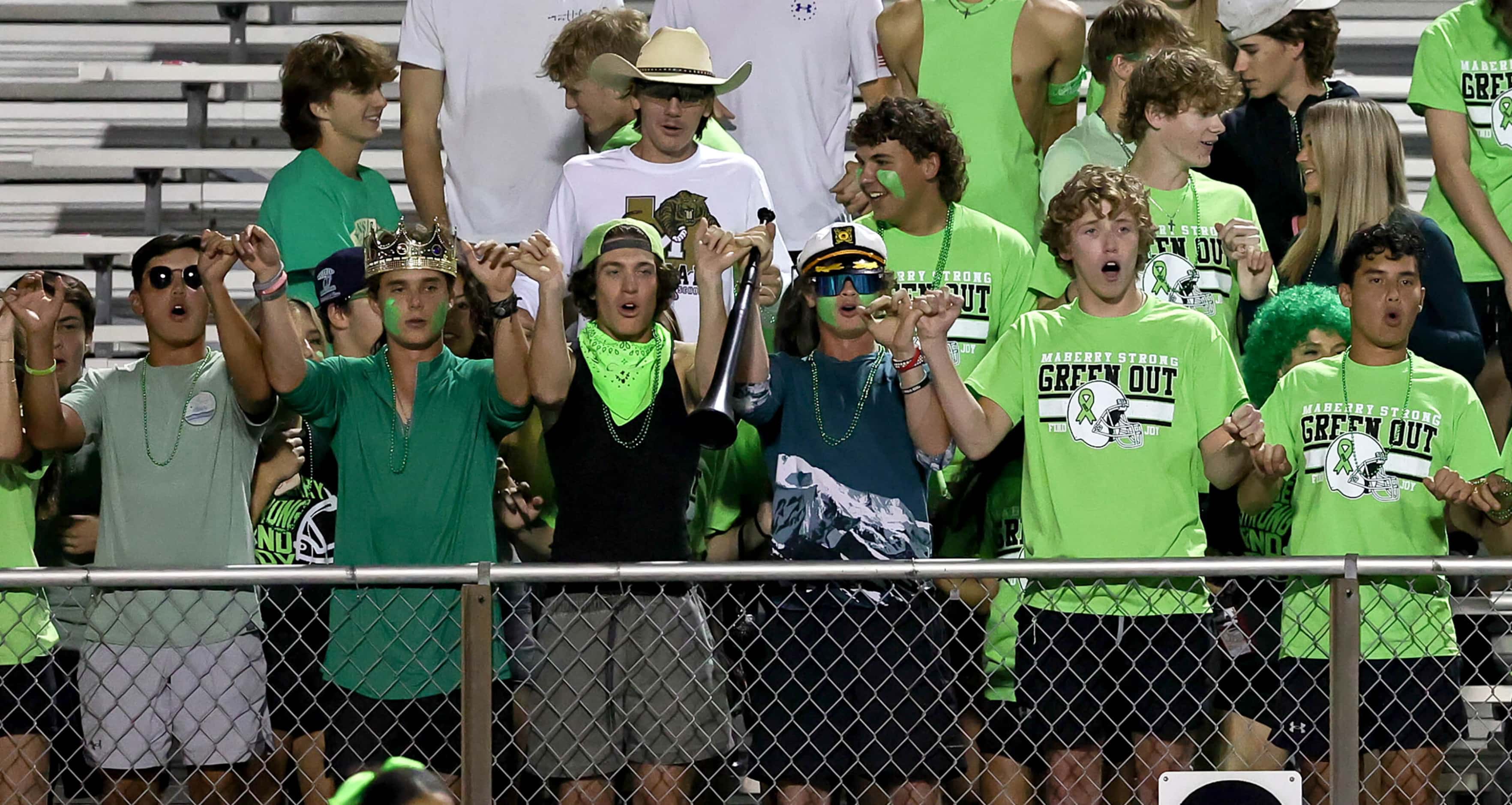 The Mansfield students cheer on their Tigers against Cedar Hill during the first half of a...