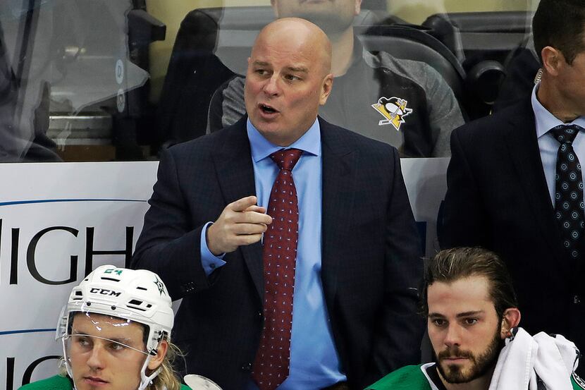Dallas Stars head coach Jim Montgomery stands behind his bench during the first period of an...