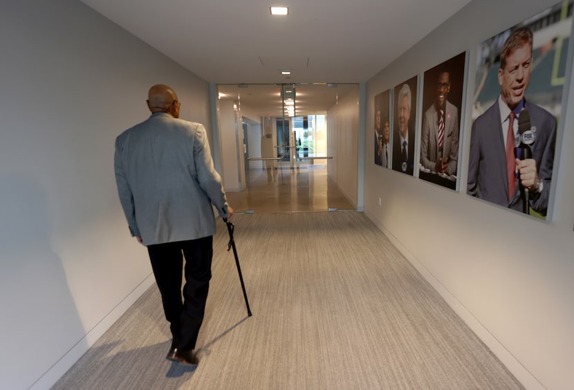 Larry Wansley, Cowboys security director, walks down a hall spotlighting  former Cowboys...