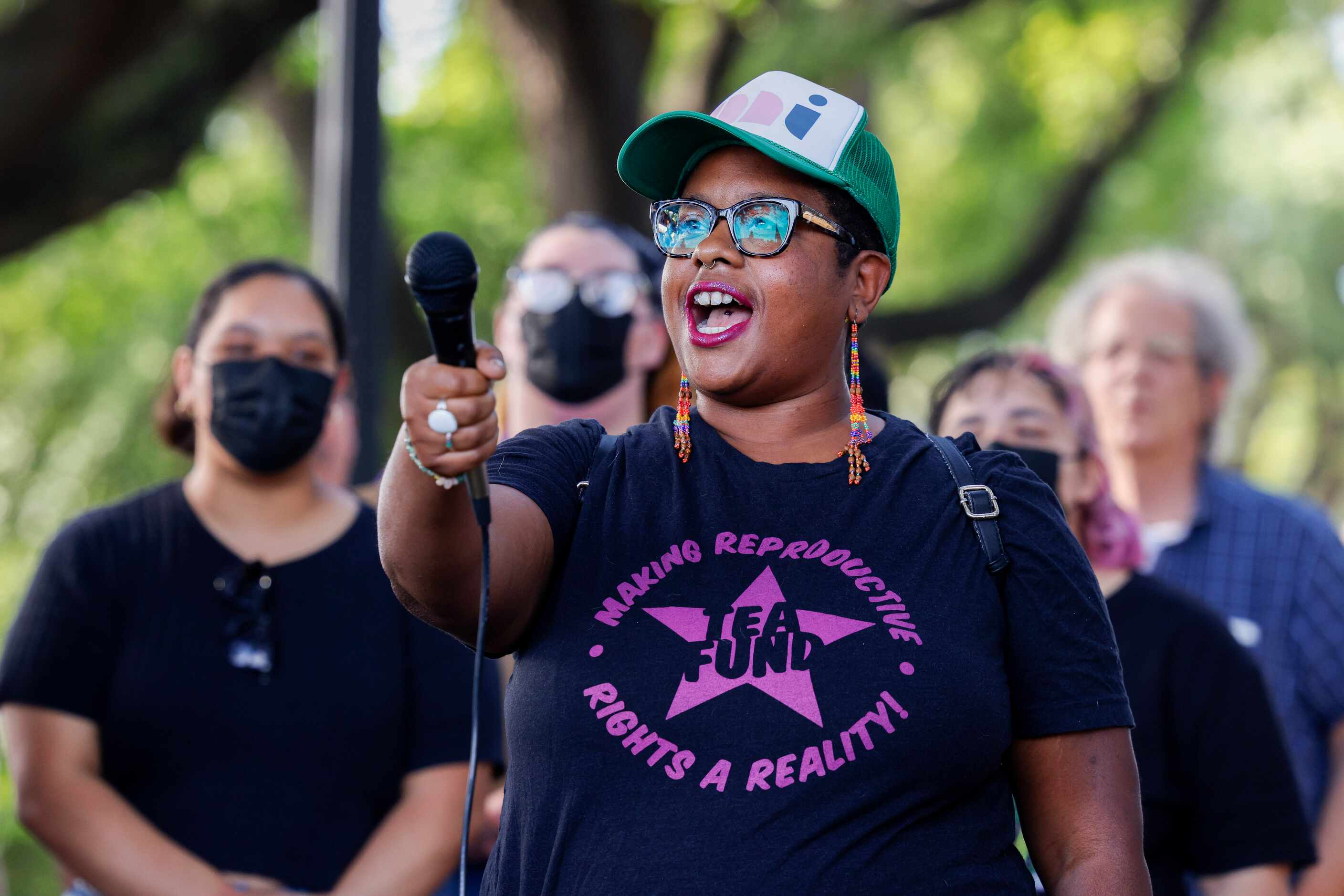 Kamyon Conner, Texas Equal Access Fund executive director, leads a chant during a rally in...