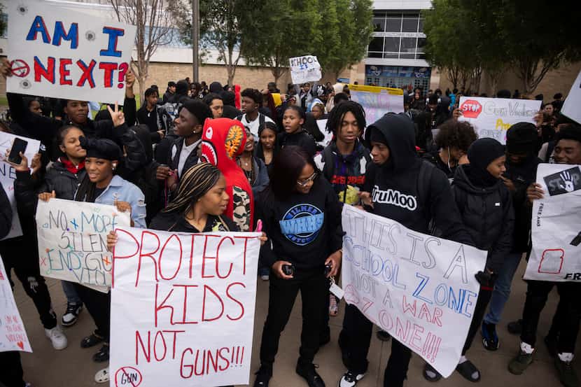 Wilmer-Hutchins High School Principal Shadaria Foster (center) looked at a student’s sign as...