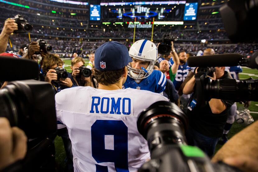 Dallas Cowboys quarterback Tony Romo (9) talks with Indianapolis Colts quarterback Andrew...