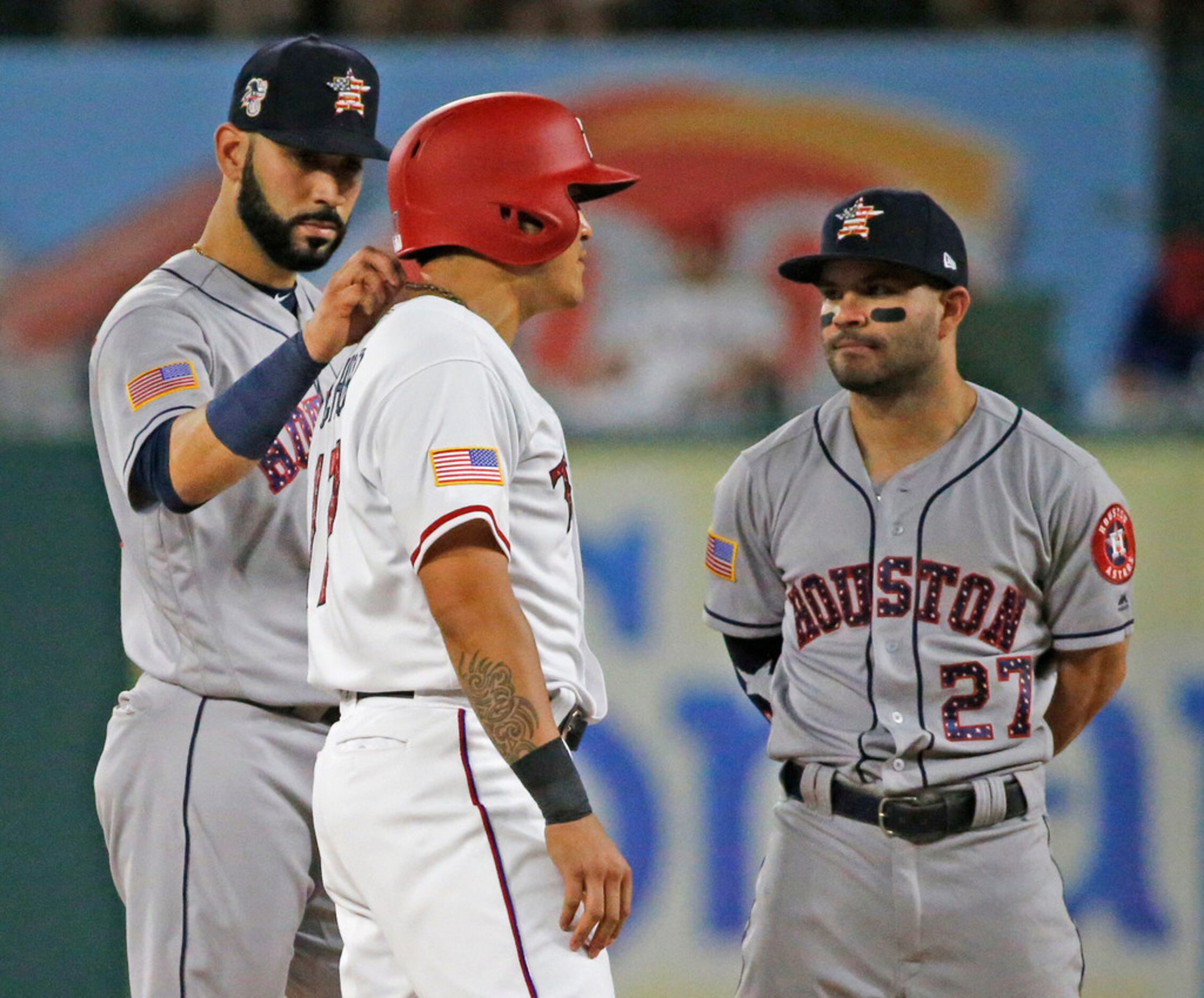 Houston Astros shortstop Marwin Gonzalez (9) and second baseman Jose Altuve (27) talk with...