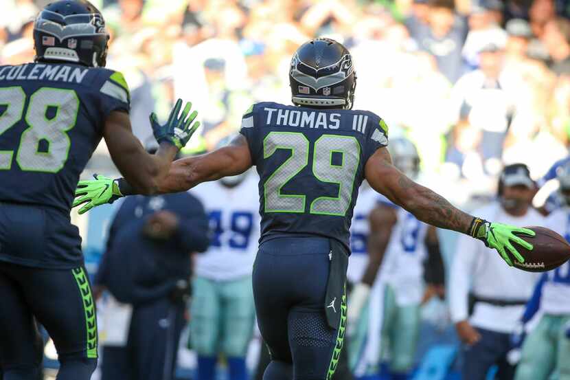 Seattle Seahawks defensive back Earl Thomas (29) runs towards the Dallas Cowboys bench after...