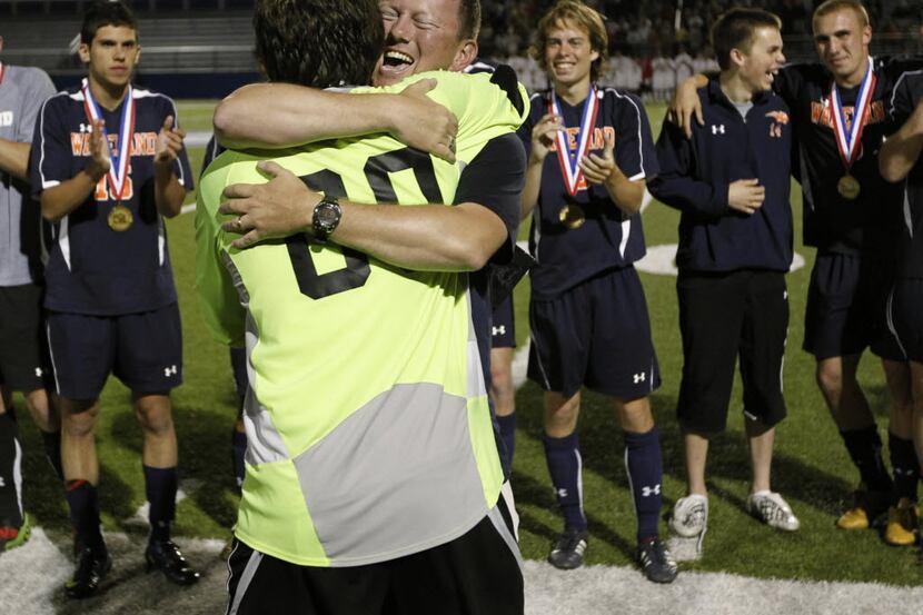 Goalkeeper Nick Petolick and coach Rusty Oglesby hugged after Frisco Wakeland defeated...
