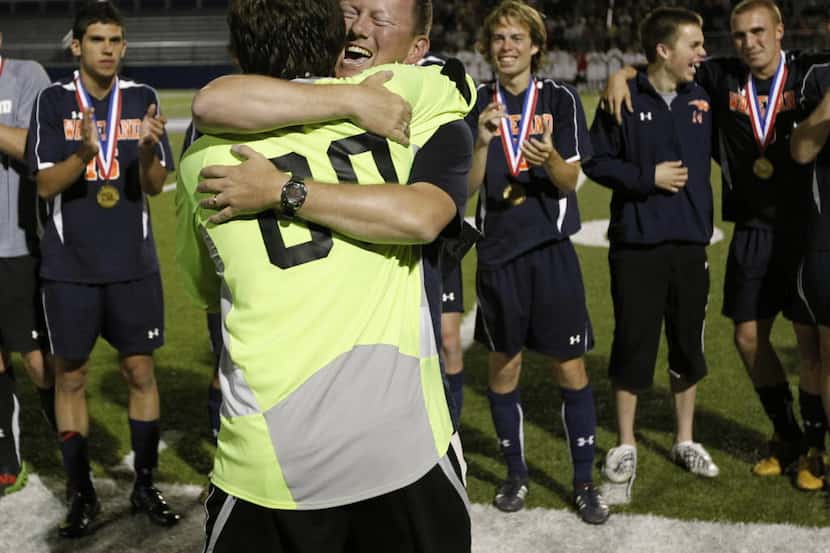 Goalkeeper Nick Petolick and coach Rusty Oglesby hug after Frisco Wakeland defeated Humble...