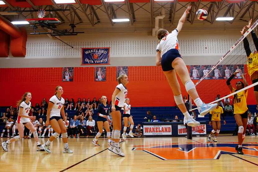 Frisco Wakeland's Jessica Jones spikes the ball during a match against Frisco Memorial on...