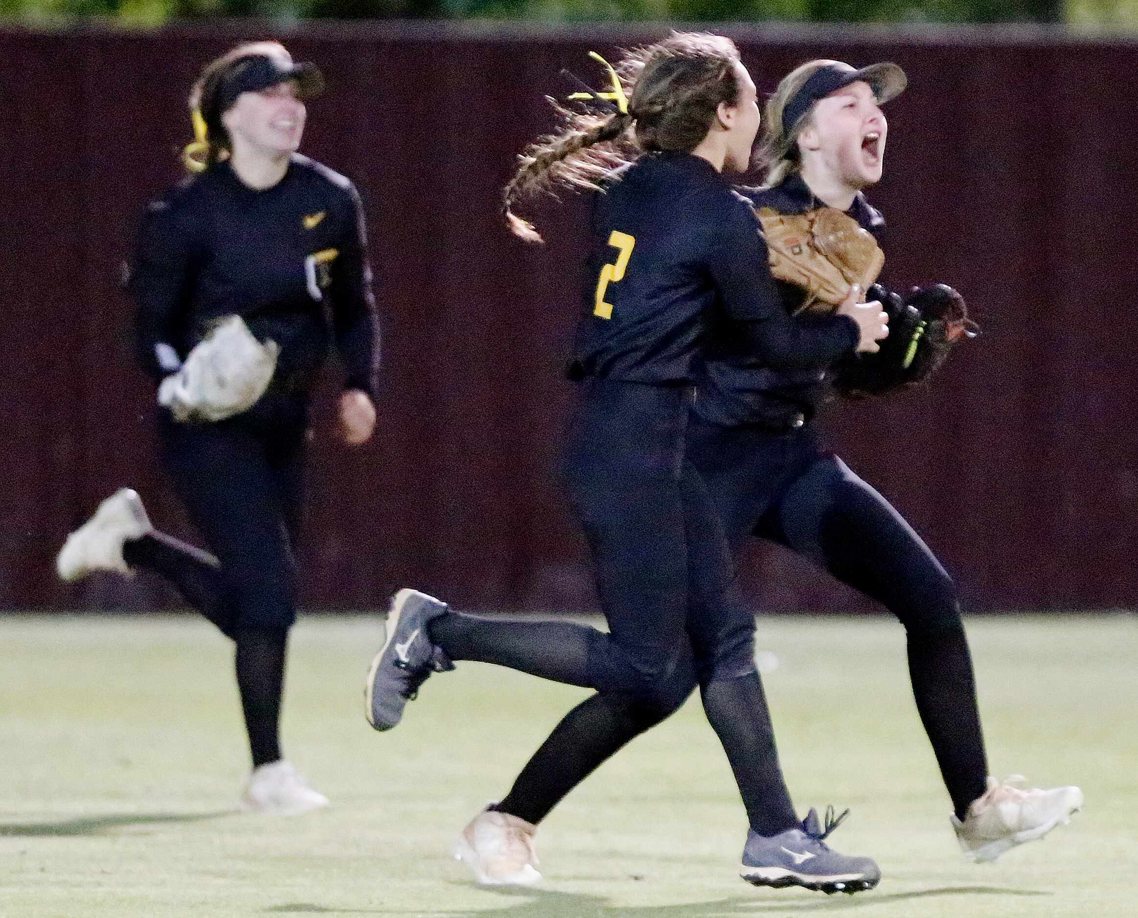 Memorial right fielder Gabby King (right) is met by second baseman Ashley Camacho (2) after...