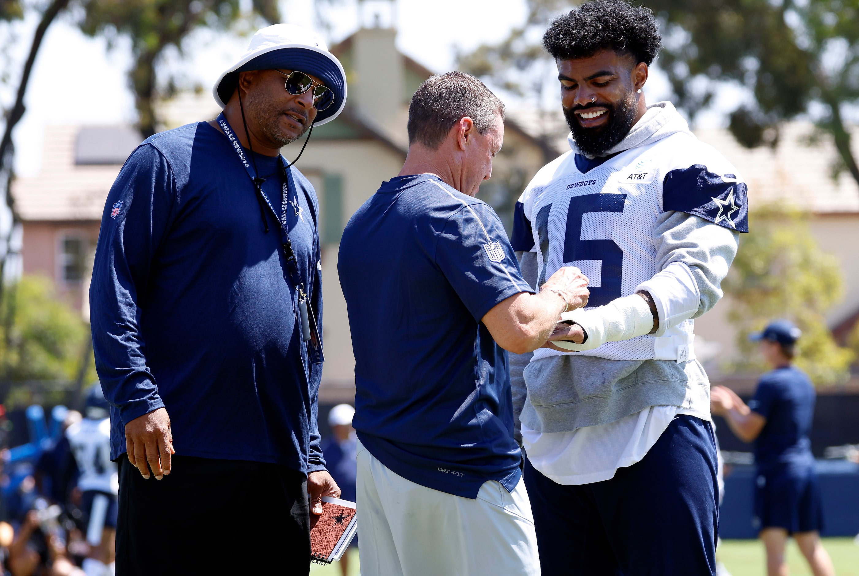 Dallas Cowboys running back Ezekiel Elliott (15) has his hands wrapped  by associate trainer...