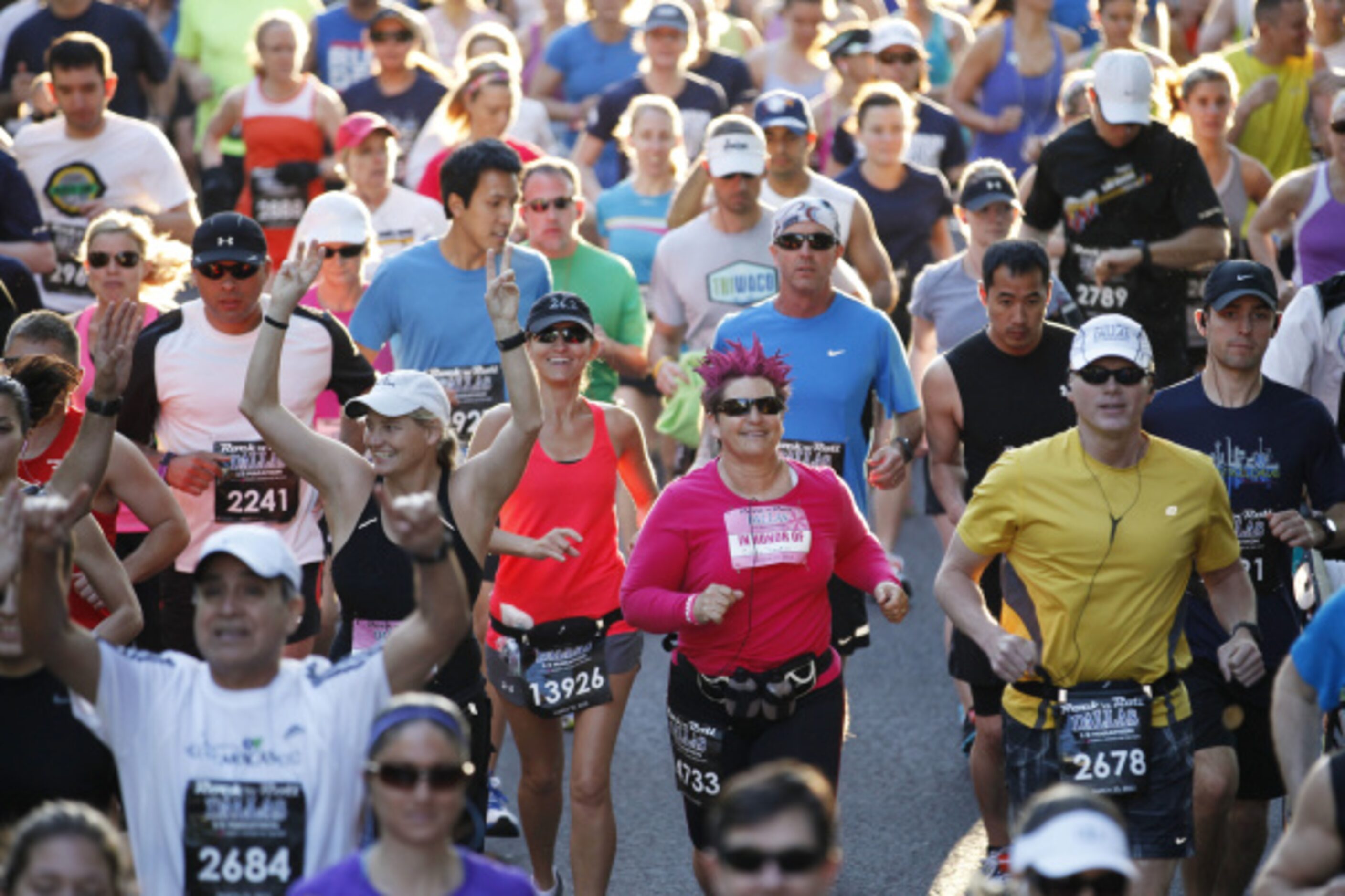 Running participants make their way down Young Street during Dallas Rock 'N' Roll half...