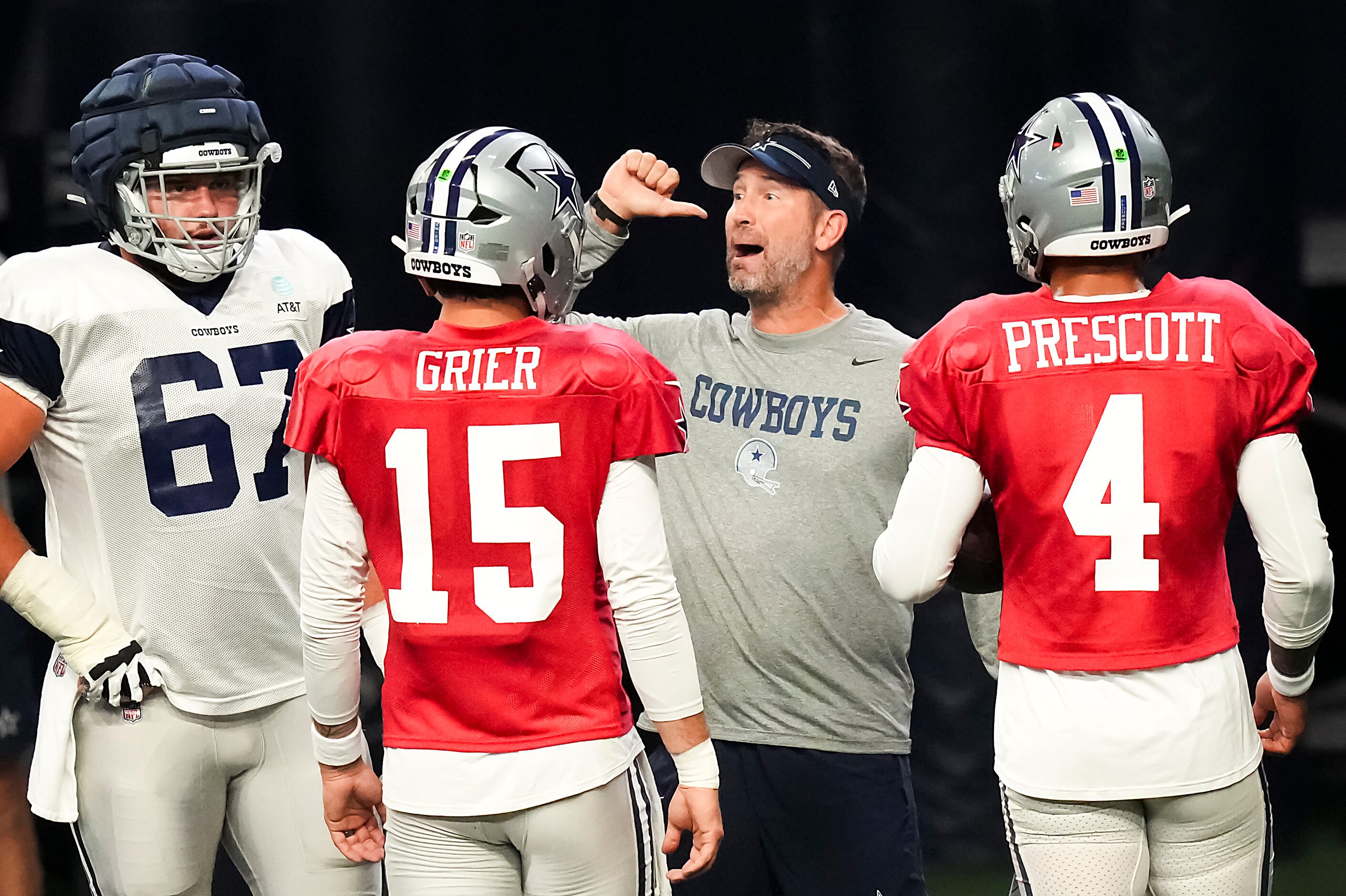 Dallas Cowboys offensive coordinator Brian Schottenheimer talks with center Brock Hoffman...