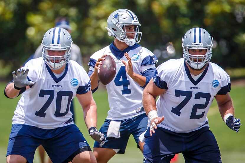 Dallas Cowboys quarterback Dak Prescott (4) throws a pass behind offensive guard Zack Martin...