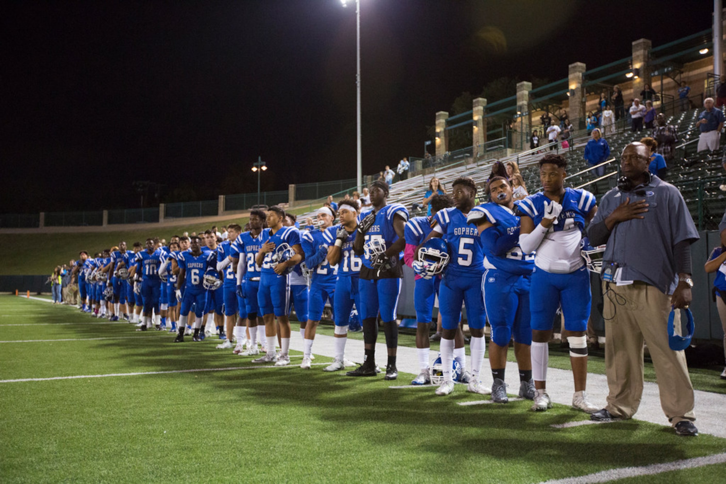 Grand Prairie lines up for the National Anthem during a District 7-6A matchup between Irving...