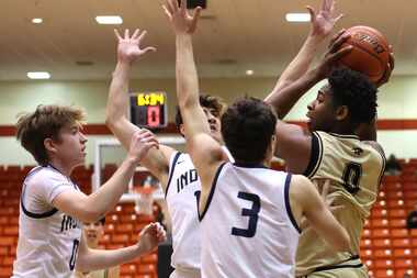 Plano East forward  DJ Hall (0), right, is swarmed by Keller defenders (left to right) Alex...