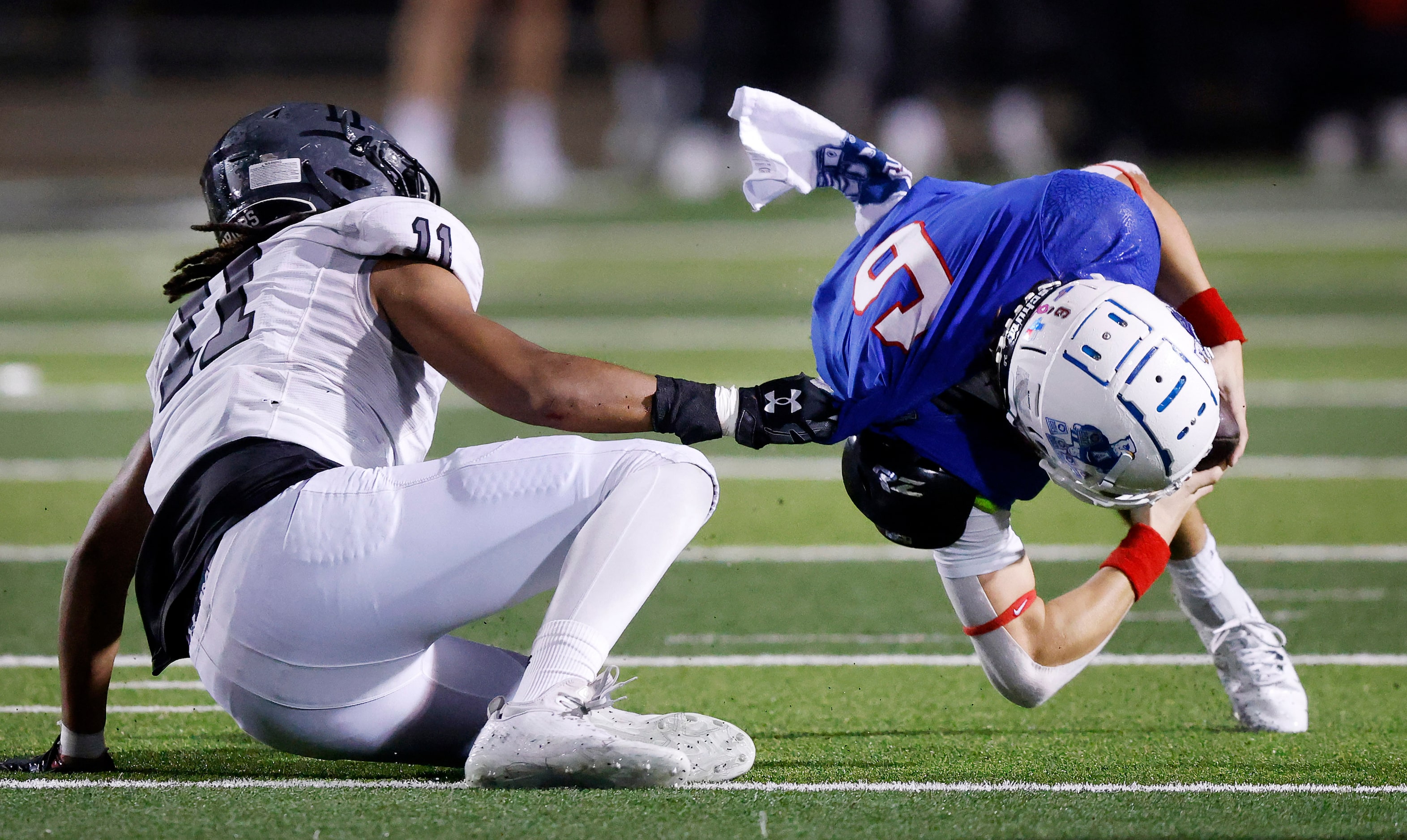 Allen quarterback Dylan Chapman (6) is slung down for a sack by Arlington Martin defensive...