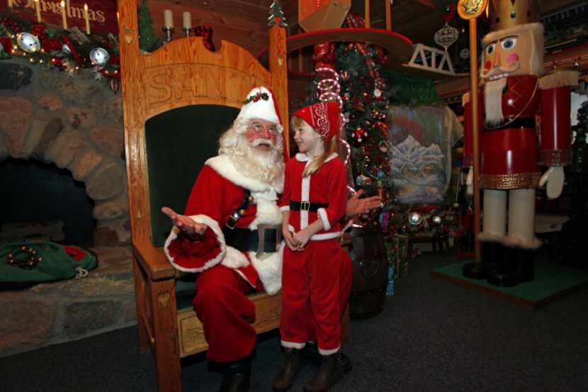 Five-year-old Kelly Derusha visits with Santa Claus in Midland, Mich., a few days before...