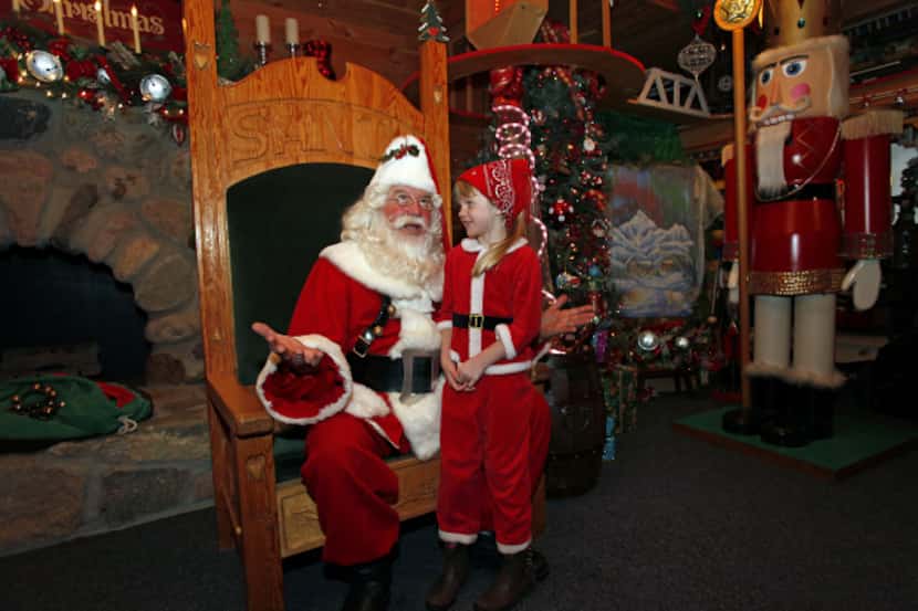 Five-year-old Kelly Derusha visits with Santa Claus in Midland, Mich., a few days before...
