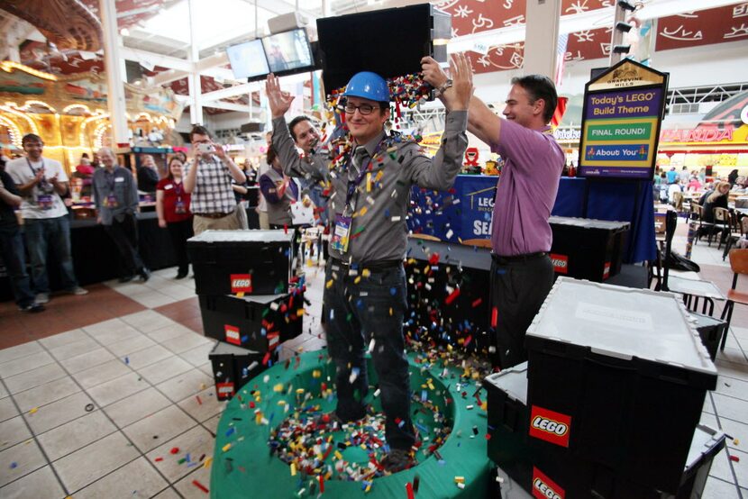 Brandon Wilke, 29, of Plano, was showered with Legos by retiring master builder Cal Walsh,...