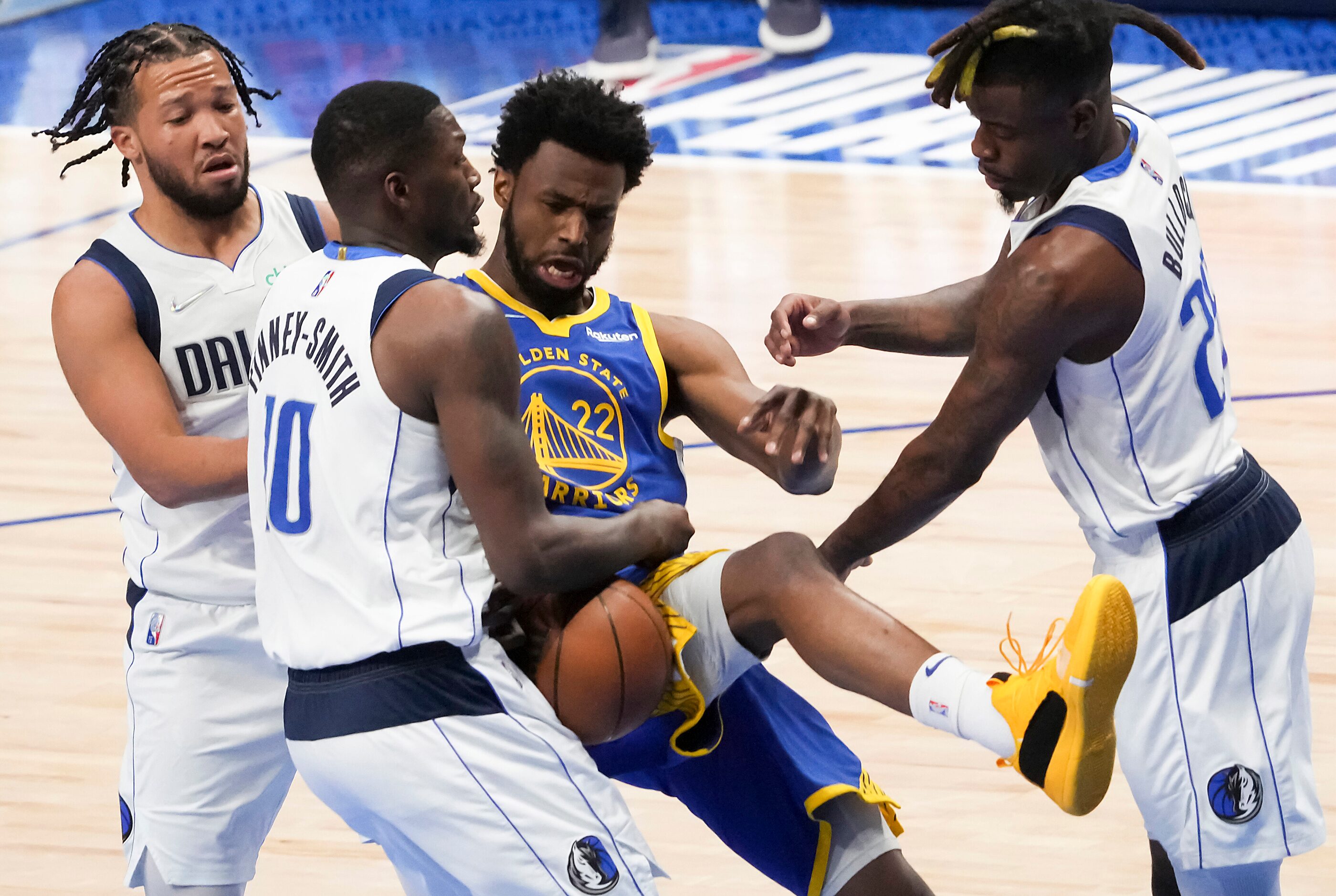 Dallas Mavericks forward Dorian Finney-Smith (10) pulls a rebound away from Golden State...