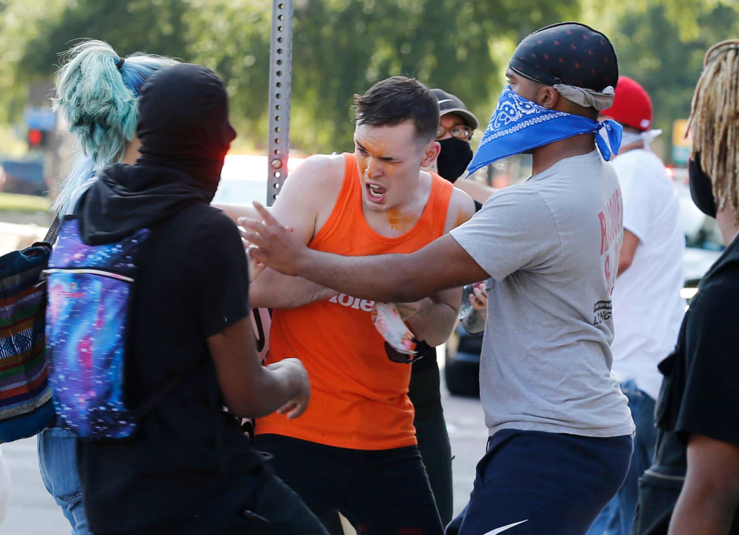 A protester is helped after being sprayed with pepperspray during a protest against police...