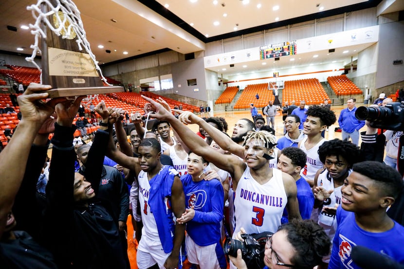 Duncanville celebrates a 66-62 overtime win in the Class 6A Region I championship boys...