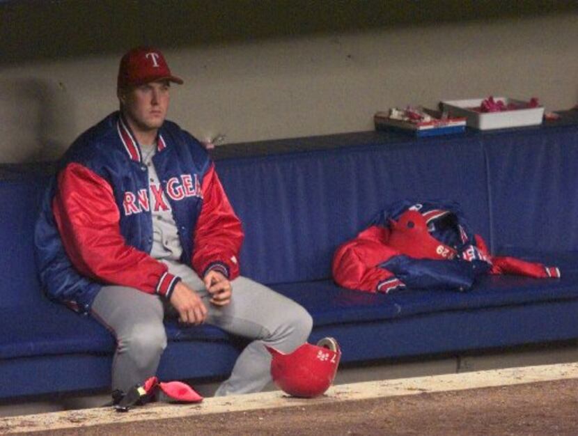 Rangers starter Rick Helling sits alone in the dugout after Texas lost 3-1 in Game 2 of the...