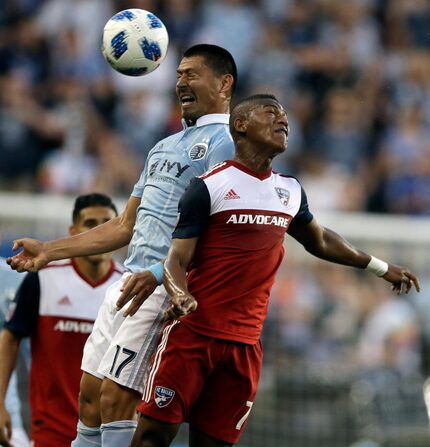 Sporting Kansas City midfielder Roger Espinoza (17) heads the ball against FC Dallas...