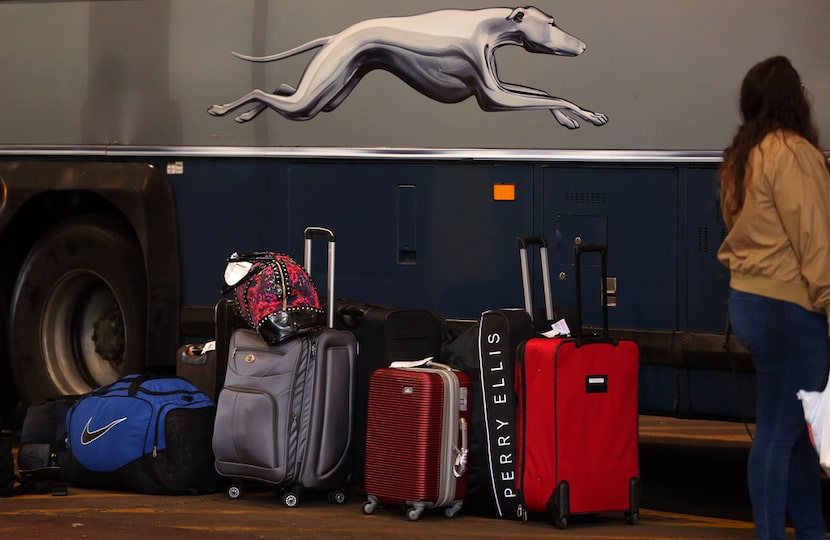 A woman waits to board a Greyhound bus at the station at 205 S. Lamar St. in Dallas on...