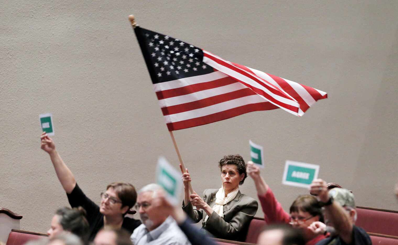 Dorothy Kuhn of Denton, waves the American flag during Congressman Michael Burgess' town...