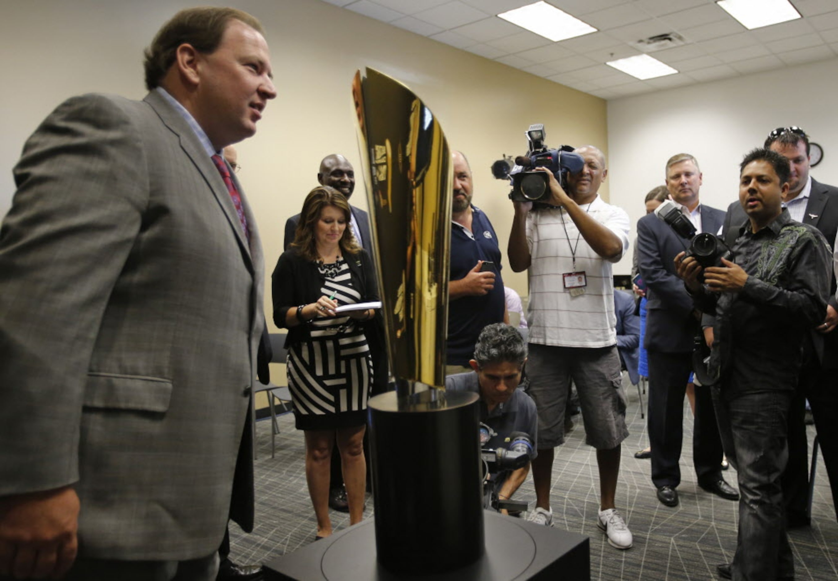 Michael Konradi of the AT&T Cotton Bowl Classic poses for a photo with the new national...