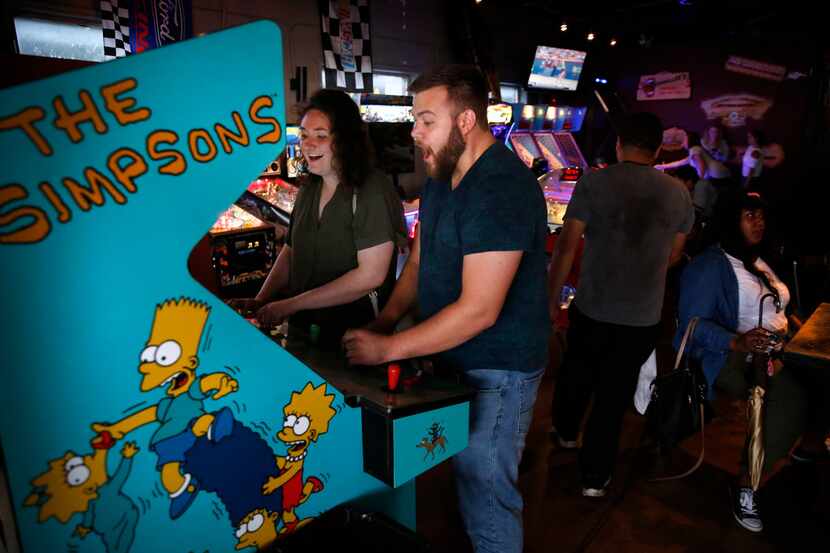 Dale Sikkema and Francesca Shell play The Simpsons video game at Barcadia in Dallas. 