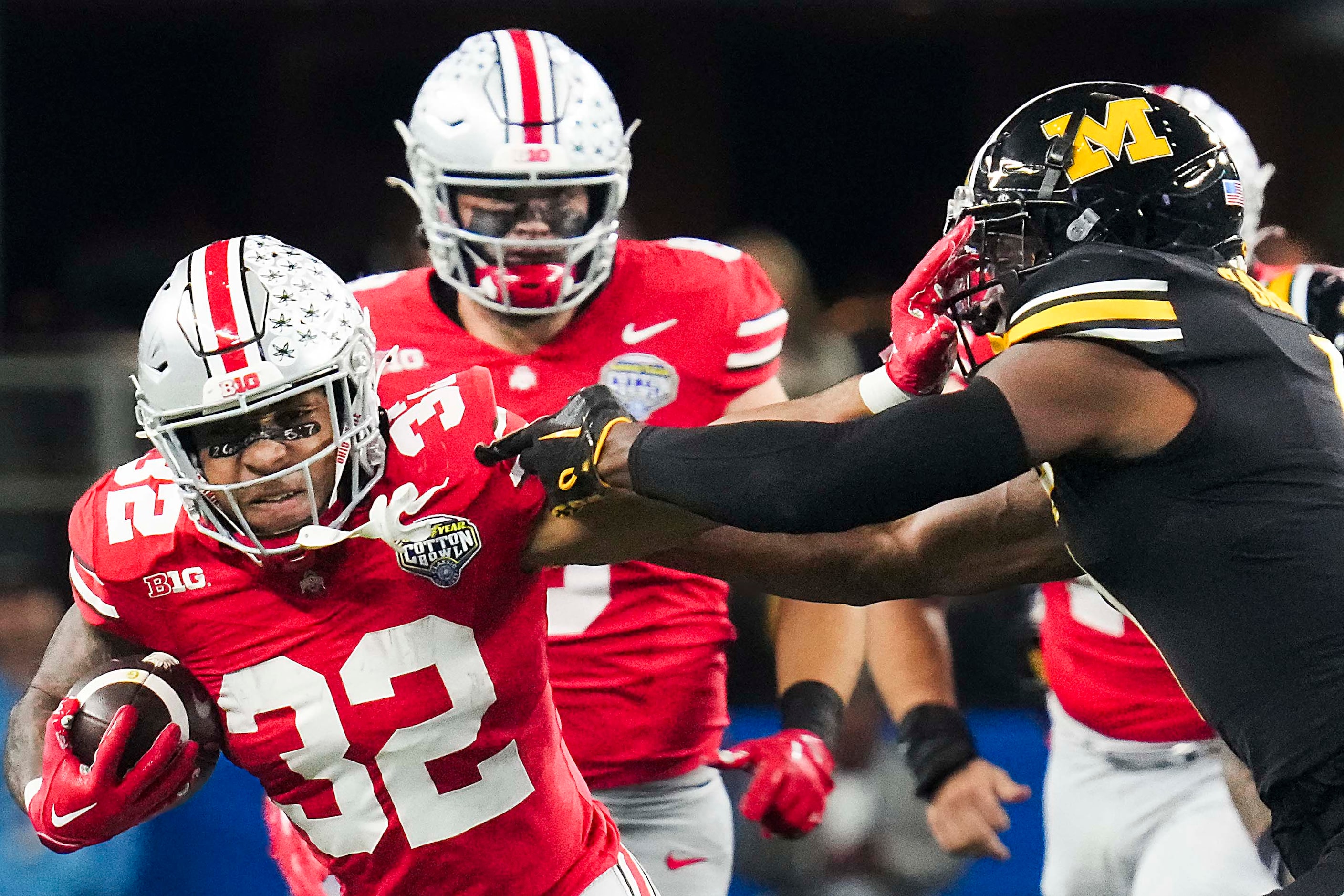 Ohio State running back TreVeyon Henderson (32) tries to push past Missouri defensive back...