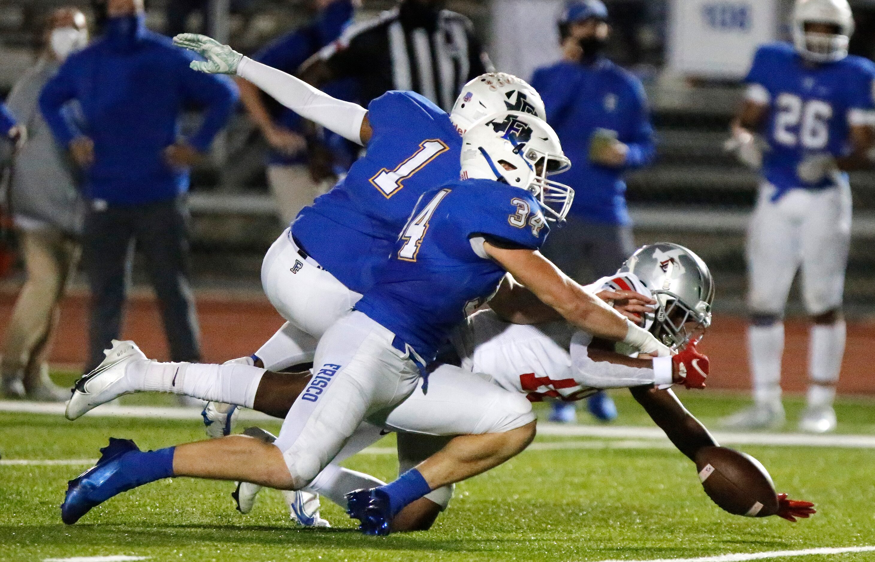 Frisco High School defensive back Myles Mays (1) and Frisco High School linebacker A.J....