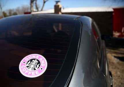 A "guns and coffee" bumper sticker is displayed on a vehicle at Lone Star Gun Club and...