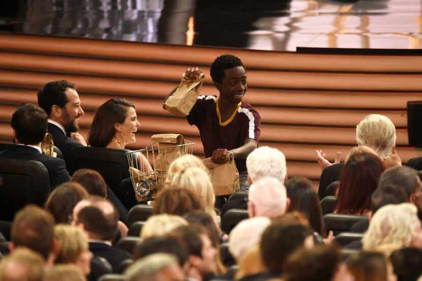 Caleb McLaughlin distributes sandwiches at the 68th Primetime Emmy Awards on Sunday, Sept....