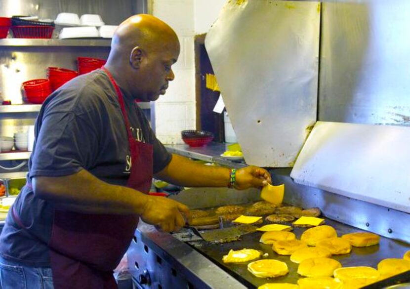 
Tony Lee has been a cook for 25 years at Club Schmitz, where he grills burgers.
