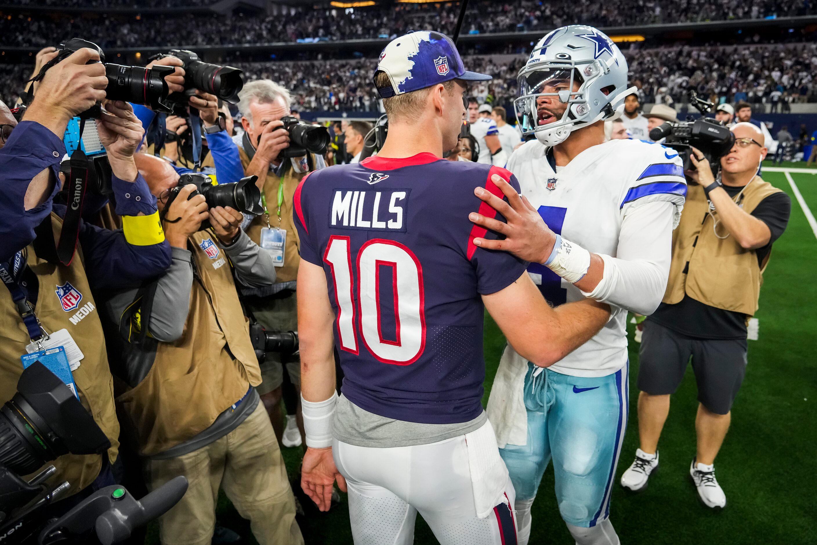 Dallas Cowboys quarterback Dak Prescott (4) talks with Houston Texans quarterback Davis...